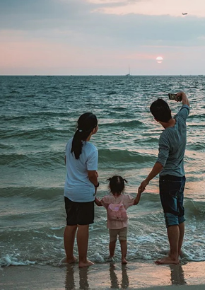 Family taking selfie on beach